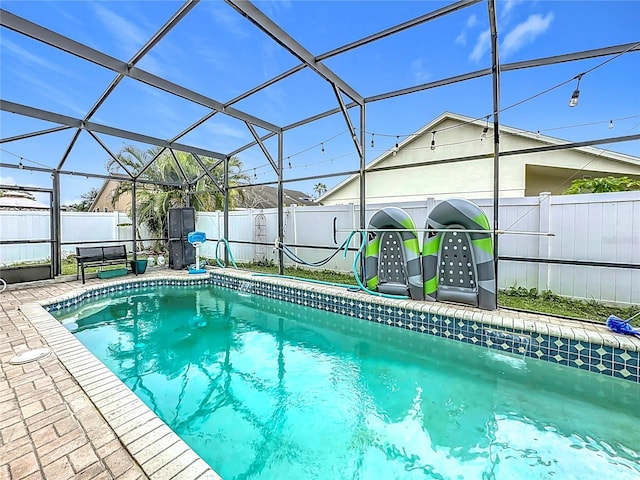 view of pool with glass enclosure