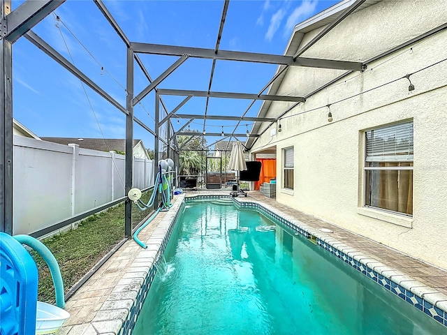 view of swimming pool with pool water feature, a lanai, a jacuzzi, and a patio