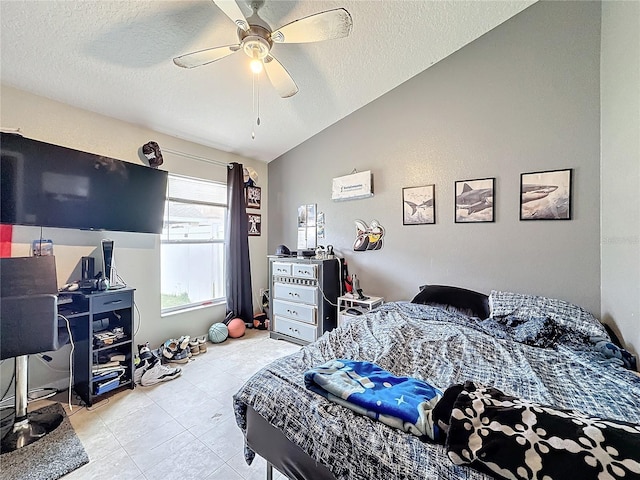 bedroom featuring ceiling fan, lofted ceiling, and a textured ceiling