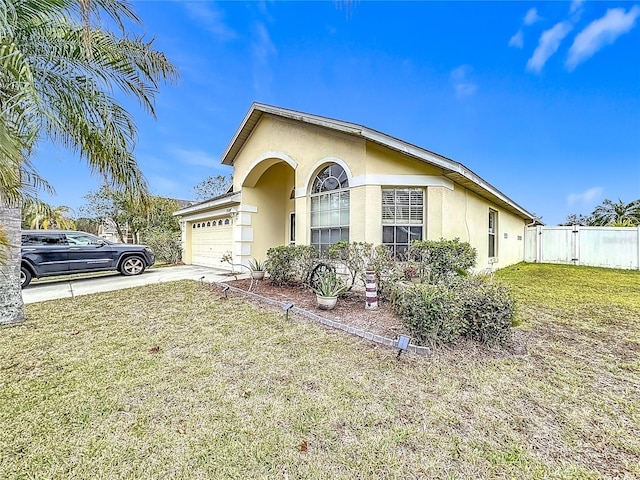 view of front of home with a garage and a front lawn