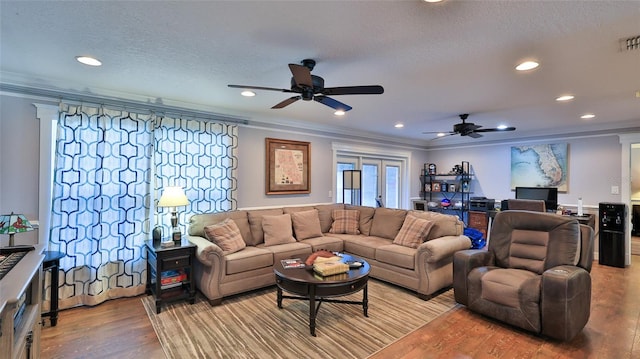 living room featuring crown molding, ceiling fan, light hardwood / wood-style floors, and french doors