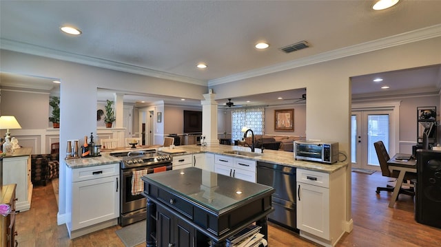 kitchen with sink, stainless steel range with electric stovetop, black dishwasher, kitchen peninsula, and white cabinets