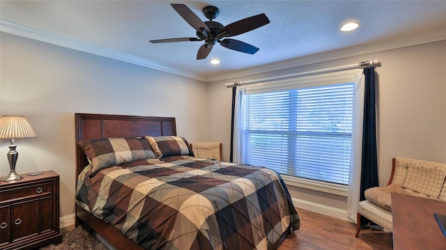 bedroom featuring ornamental molding, dark hardwood / wood-style floors, and ceiling fan