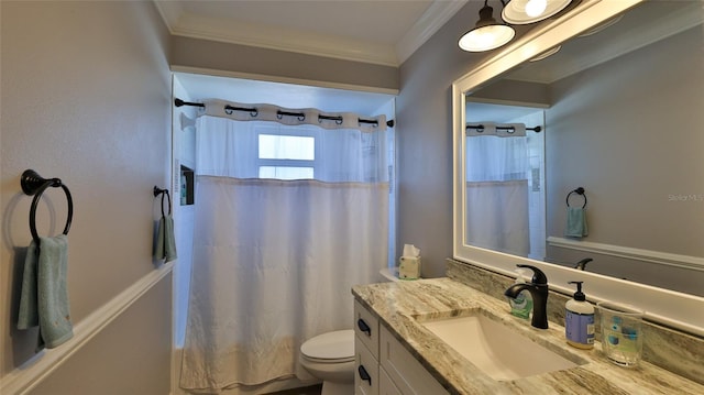 bathroom featuring ornamental molding, vanity, and toilet