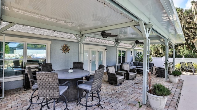 view of patio with an outdoor hangout area, french doors, and ceiling fan