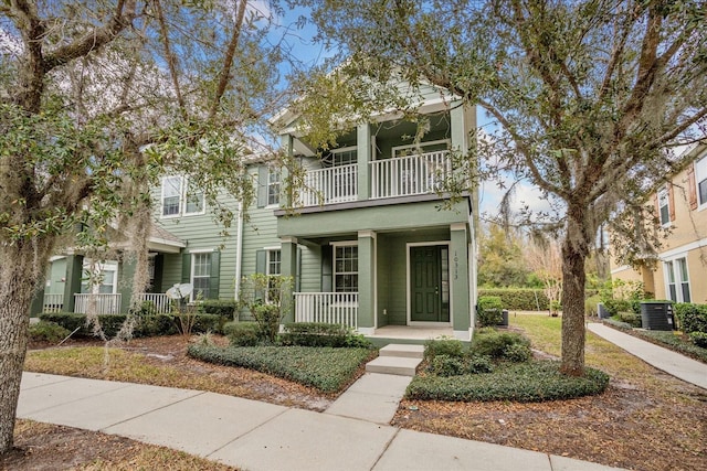 view of front of home featuring central AC unit, a porch, and a balcony