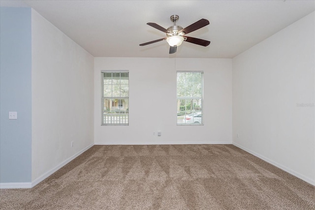 spare room featuring ceiling fan and carpet flooring