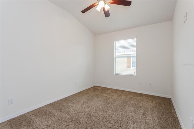 carpeted spare room featuring ceiling fan and vaulted ceiling