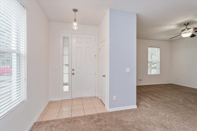 entrance foyer featuring light carpet and ceiling fan