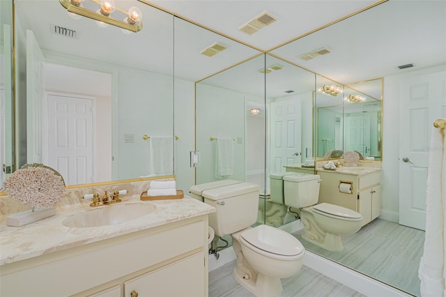 bathroom with toilet and vanity