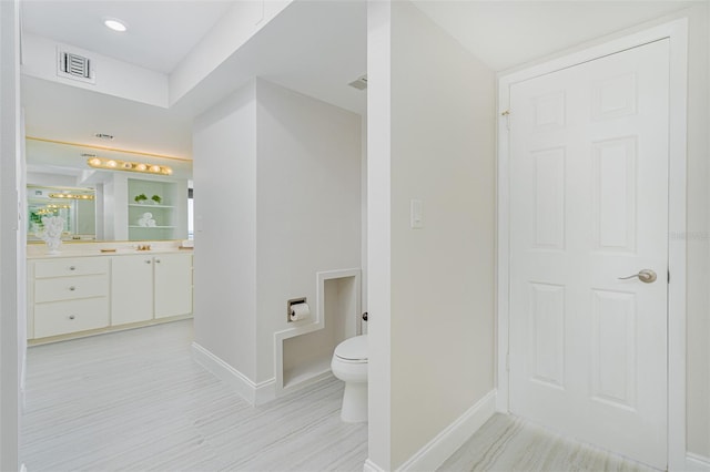 bathroom with toilet and vanity