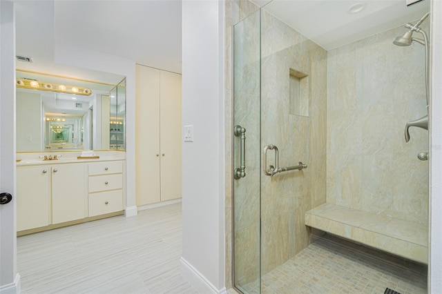 bathroom featuring walk in shower and vanity