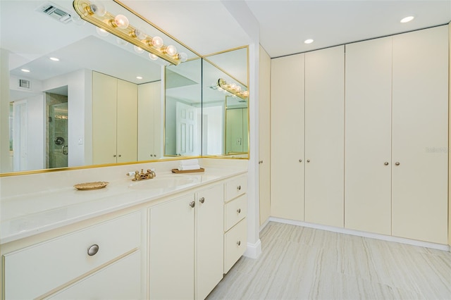 bathroom with walk in shower and vanity