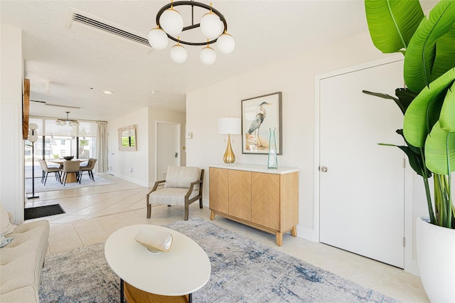 living room featuring light tile patterned floors and a notable chandelier