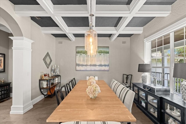 dining space with beam ceiling, coffered ceiling, and decorative columns