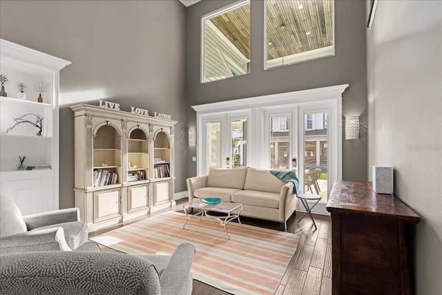 living room featuring hardwood / wood-style flooring and a high ceiling