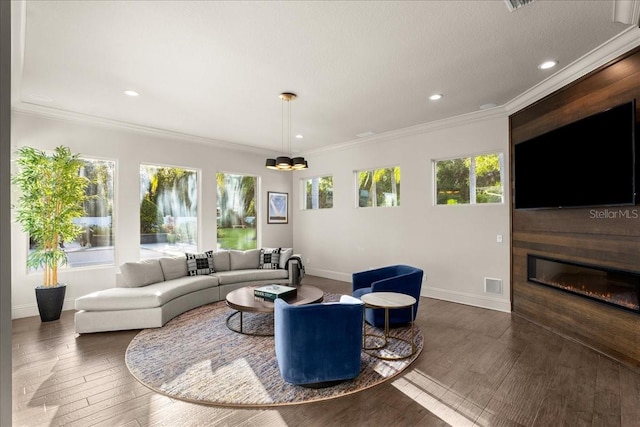 living room featuring a wealth of natural light, dark hardwood / wood-style floors, and crown molding