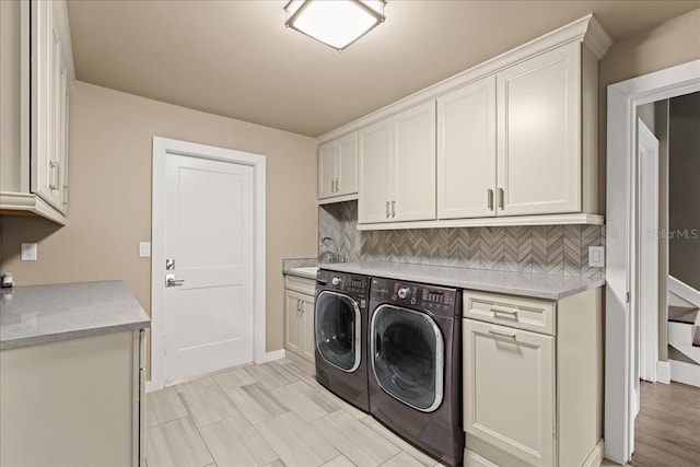 laundry area with cabinets and washer and clothes dryer