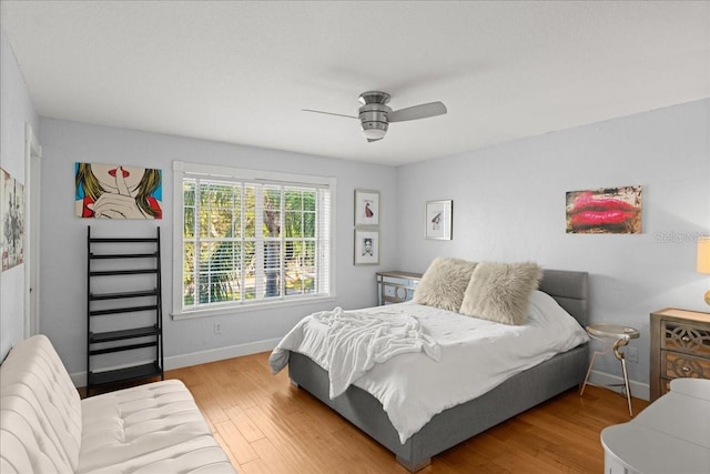 bedroom with ceiling fan and light wood-type flooring