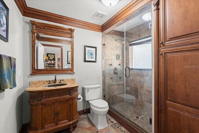 bathroom with a textured ceiling, a shower with door, ornamental molding, and vanity