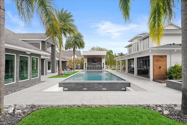 view of pool featuring a patio area and a bar