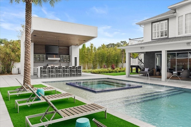 view of pool featuring ceiling fan, a patio area, an in ground hot tub, and an outdoor bar