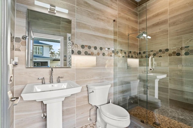 bathroom featuring toilet, tile walls, and walk in shower