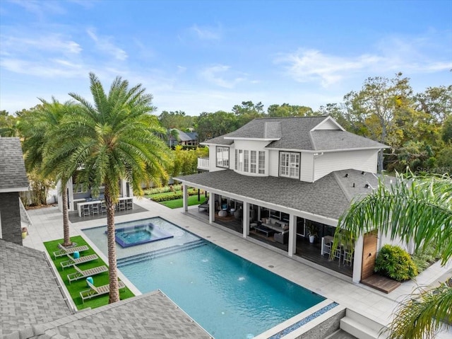 view of swimming pool with exterior bar, a patio, and an in ground hot tub