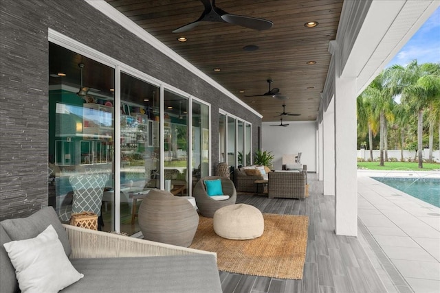 view of patio / terrace with ceiling fan, outdoor lounge area, and a fenced in pool