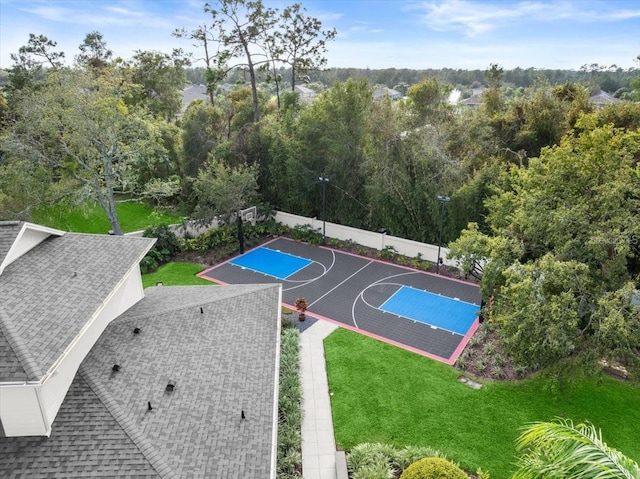 view of sport court featuring a yard