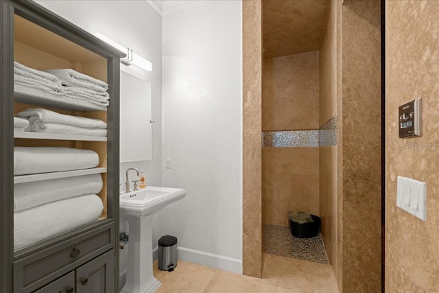 bathroom featuring walk in shower, sink, tile patterned floors, and ornamental molding