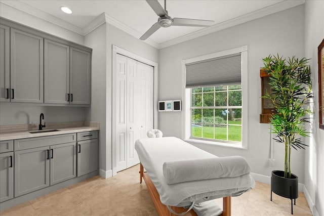 bedroom featuring ceiling fan, sink, a closet, and ornamental molding