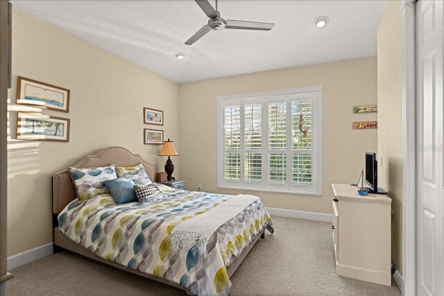 bedroom featuring ceiling fan and light colored carpet