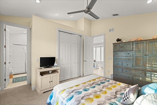 carpeted bedroom featuring vaulted ceiling, ceiling fan, and a closet