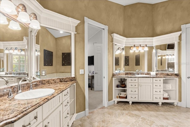 bathroom featuring a towering ceiling and vanity