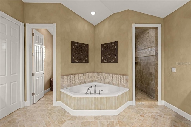 bathroom with vaulted ceiling and independent shower and bath