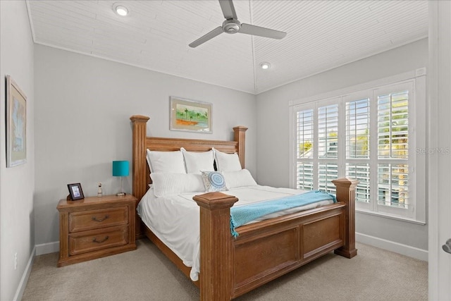 bedroom featuring ceiling fan, light colored carpet, and vaulted ceiling