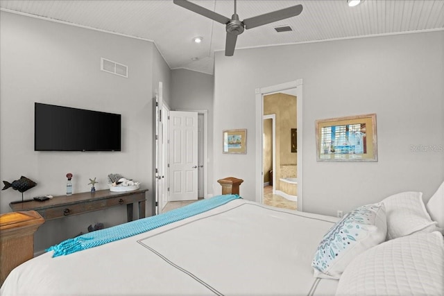 bedroom featuring ceiling fan, ensuite bathroom, and lofted ceiling