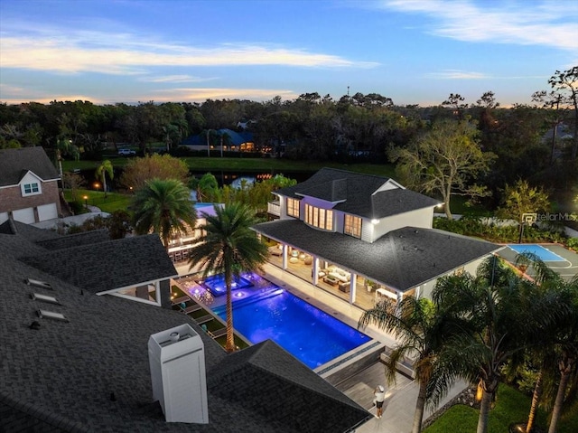 pool at dusk with a patio