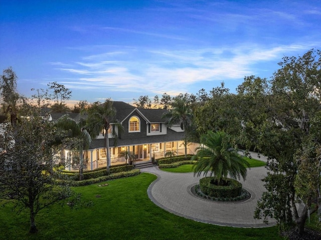 rear view of property with a yard