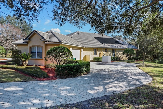 ranch-style home featuring a garage