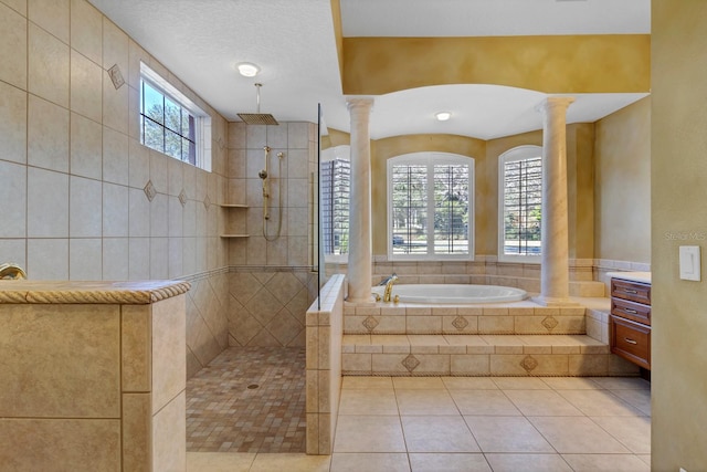 bathroom with tile patterned floors, vanity, ornate columns, and plus walk in shower