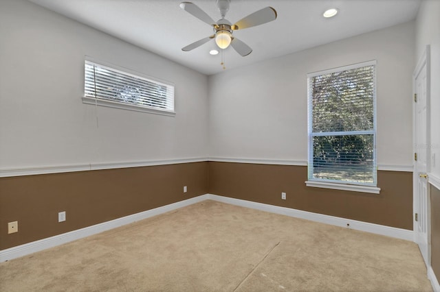 empty room featuring light carpet and ceiling fan