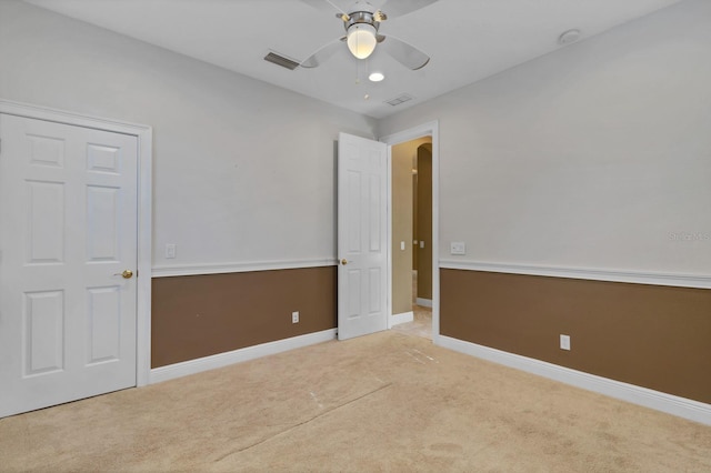 carpeted empty room with ceiling fan