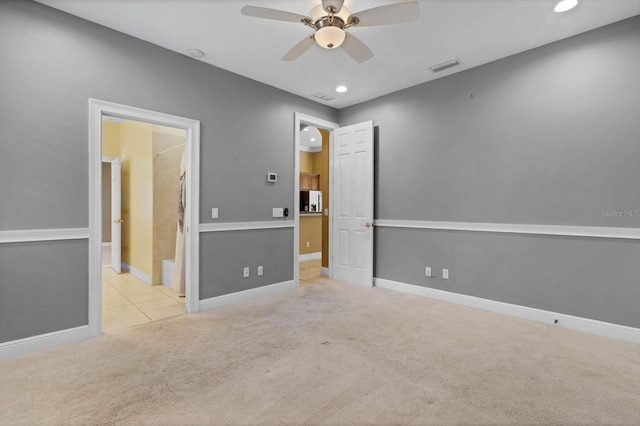 carpeted empty room featuring ceiling fan