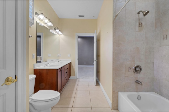 full bathroom with toilet, tiled shower / bath, tile patterned floors, and vanity