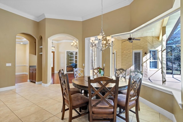 tiled dining space featuring ceiling fan with notable chandelier, built in shelves, and crown molding