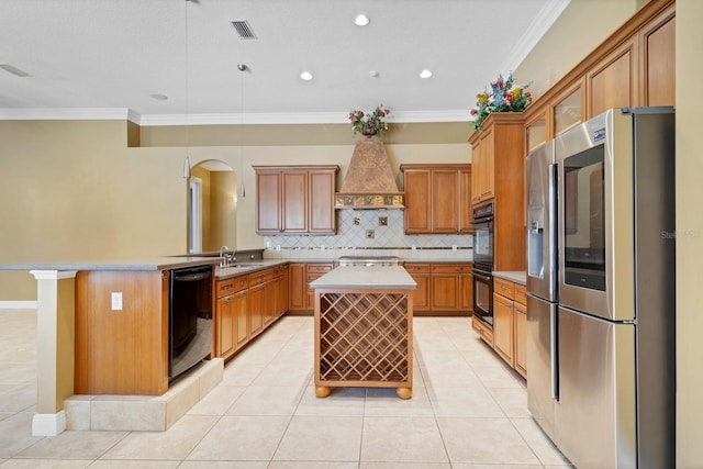 kitchen with ornamental molding, a kitchen breakfast bar, black appliances, and a center island