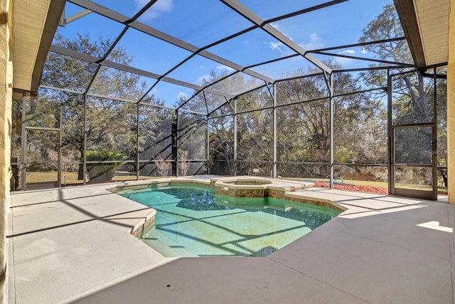 view of swimming pool featuring glass enclosure, an in ground hot tub, and a patio