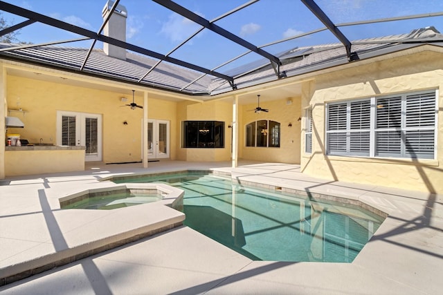 view of swimming pool with ceiling fan, french doors, a patio area, and an in ground hot tub